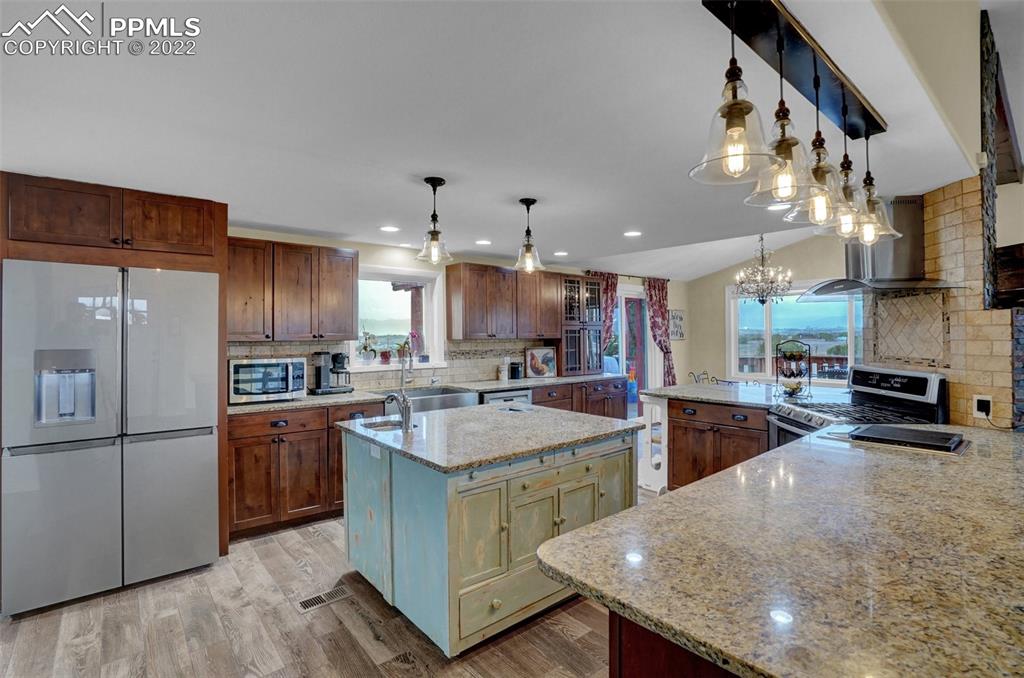 1451 R Street Penrose, CO 81240 - Photo 7 of 50 a kitchen with stainless steel appliances granite countertop a sink a stove and a refrigerator