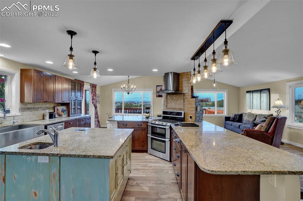 1451 R Street Penrose, CO 81240 - Photo 8 of 50 a kitchen with stainless steel appliances granite countertop a sink a stove and a refrigerator