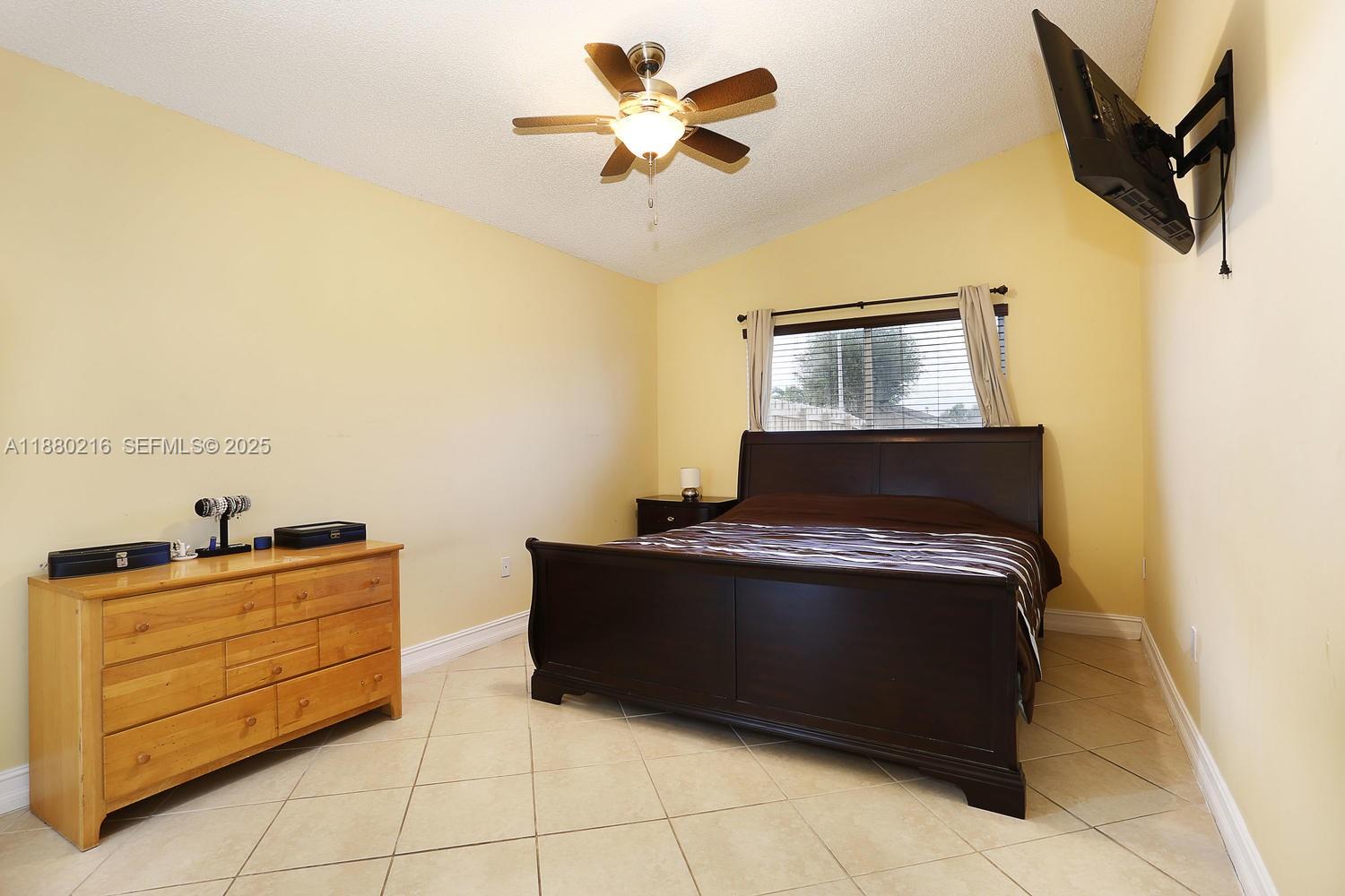 14285 Southwest 176th Terrace Miami, FL 33177 - Photo 12 of 20 a room with a bed and cabinets