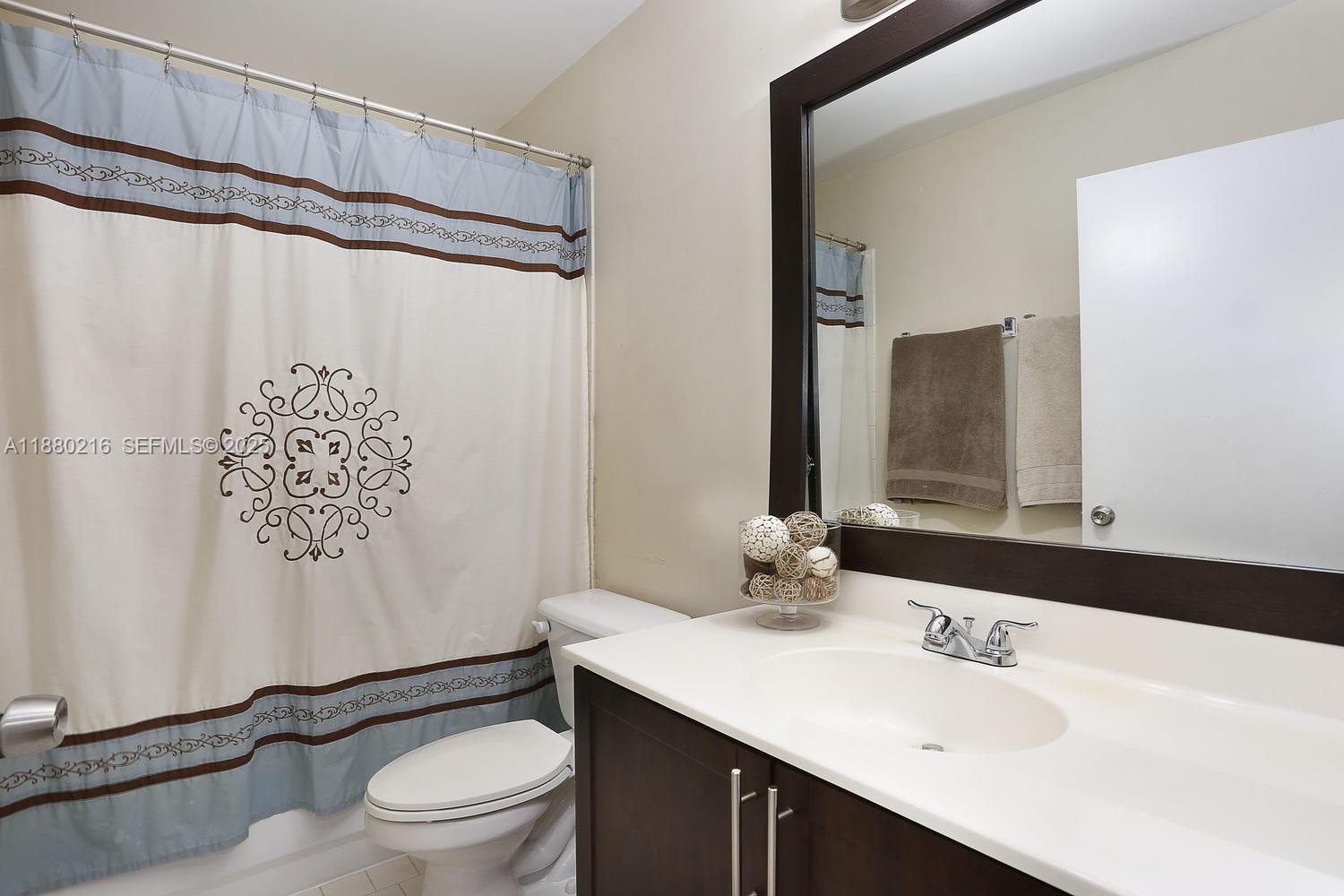 14285 Southwest 176th Terrace Miami, FL 33177 - Photo 15 of 20 a bathroom with a sink a toilet and shower
