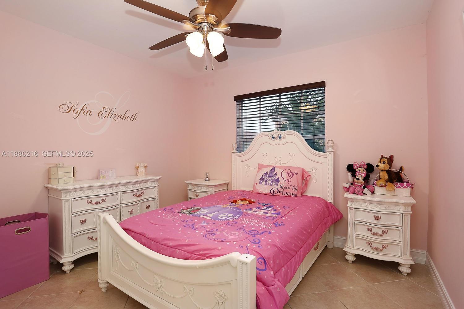 14285 Southwest 176th Terrace Miami, FL 33177 - Photo 17 of 20 a bedroom with a bed and a chandelier