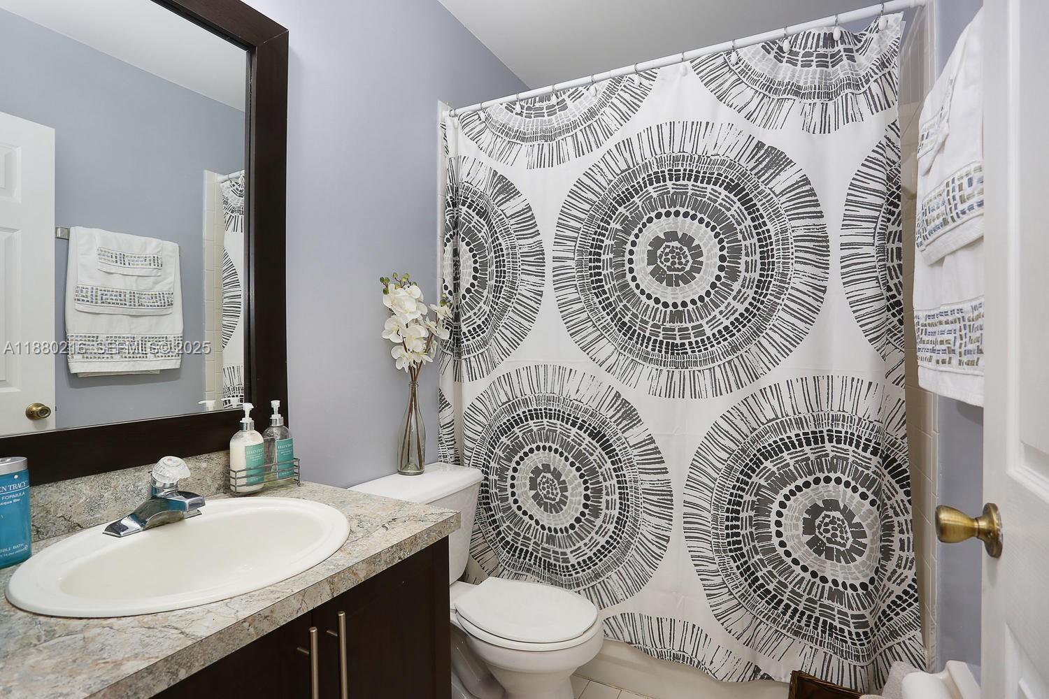 14285 Southwest 176th Terrace Miami, FL 33177 - Photo 18 of 20 a bathroom with a sink a mirror and a toilet