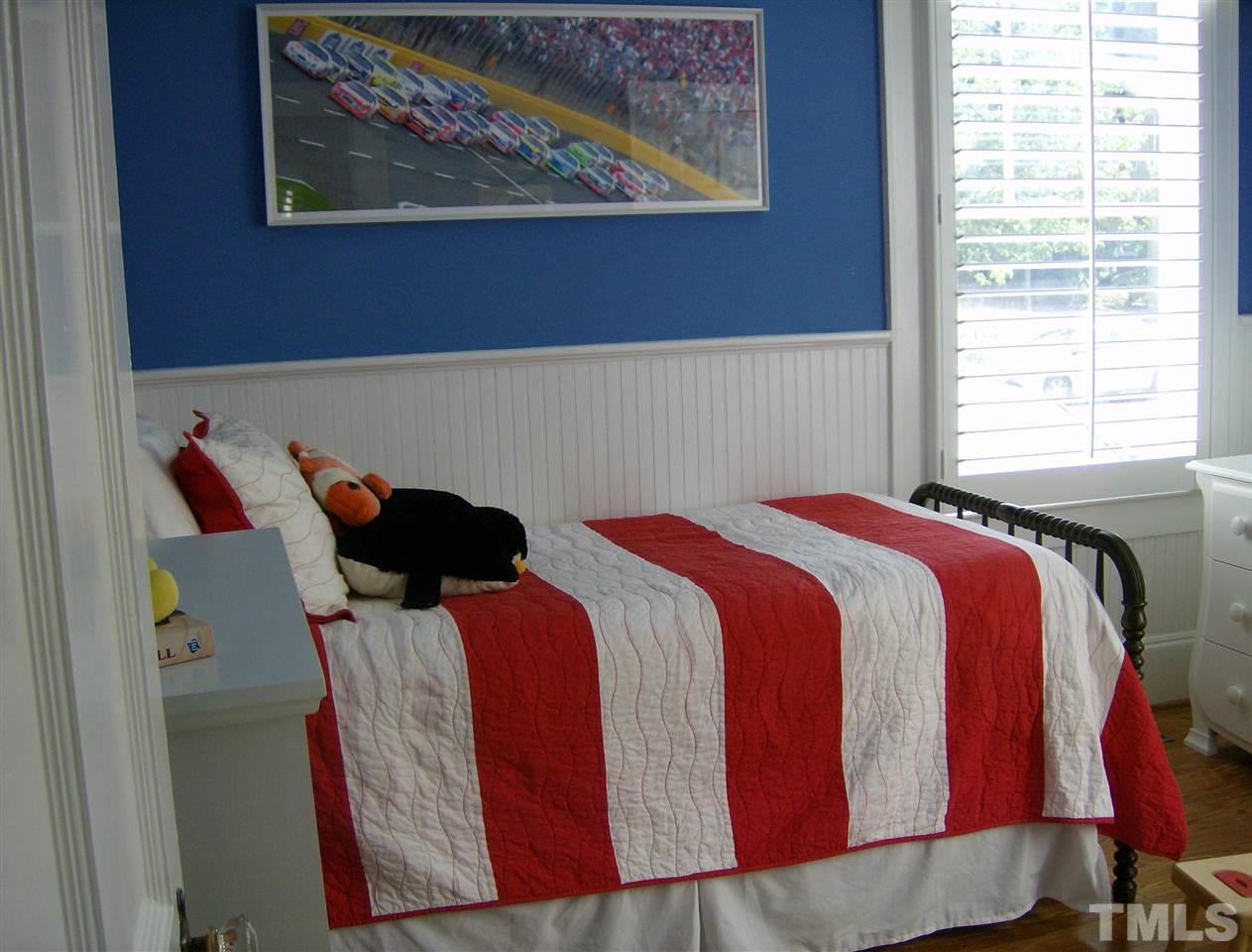 919 West Johnson Street Raleigh, NC 27605 - Photo 11 of 20 a bed sitting in a bedroom next to a window