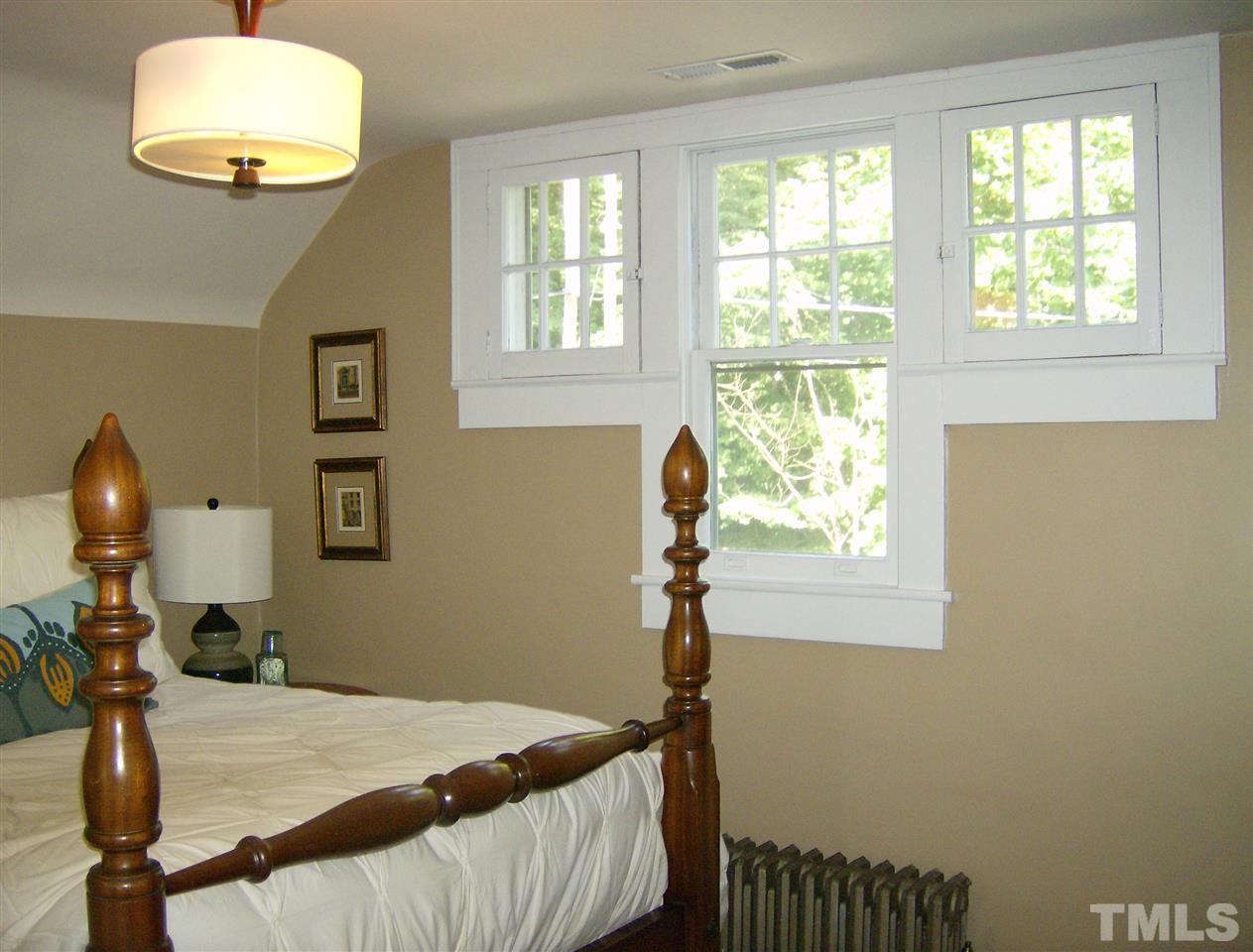 919 West Johnson Street Raleigh, NC 27605 - Photo 13 of 20 a bedroom with a bed and a window