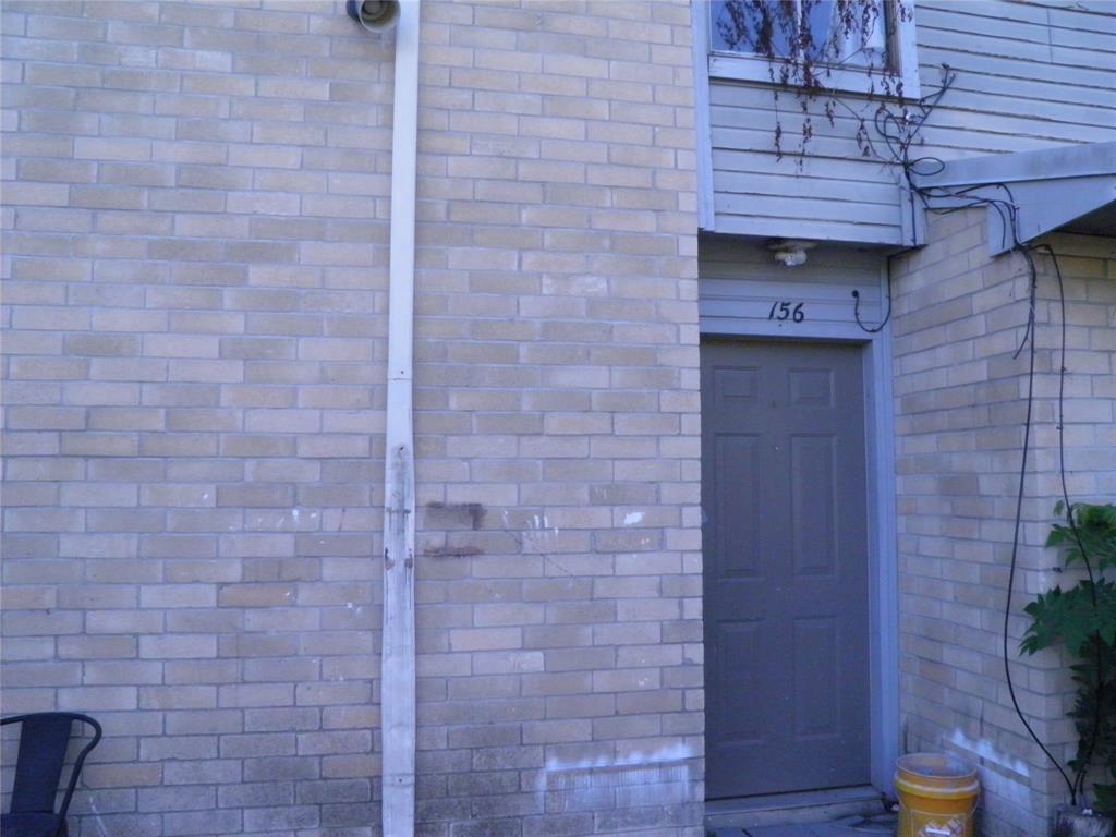 a brick room with a wooden door