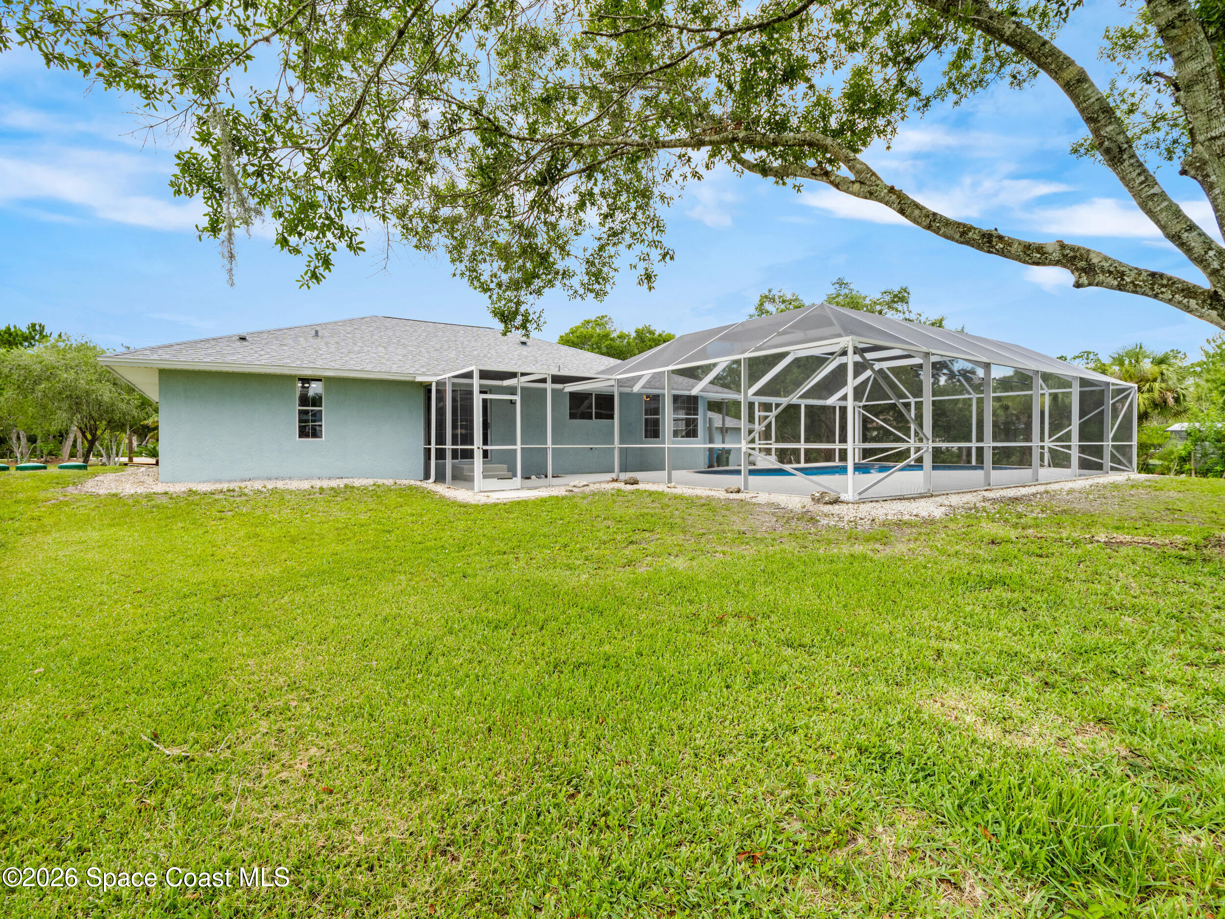 3480 Weber Road Malabar, FL 32950 - Photo 27 of 45 a front view of a house with a garden and lake view