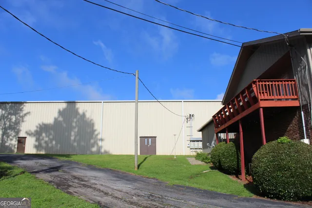 a view of street along with house and trees