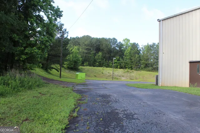a backyard of a house with lots of green space table and chairs
