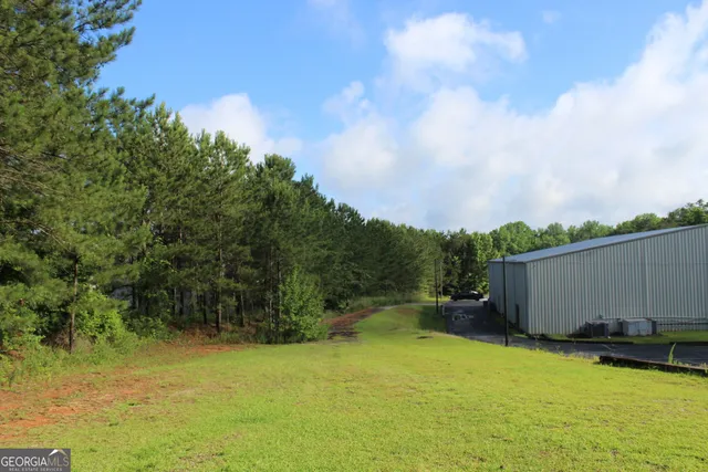 a view of a white house with a outdoor space