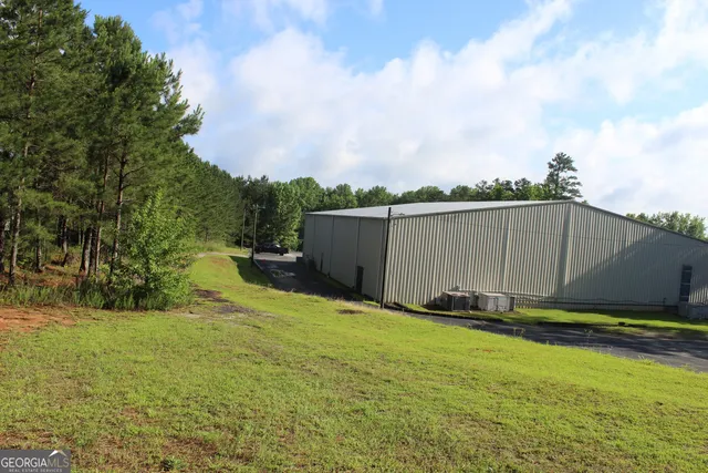 a bedroom with a bed and a lamp