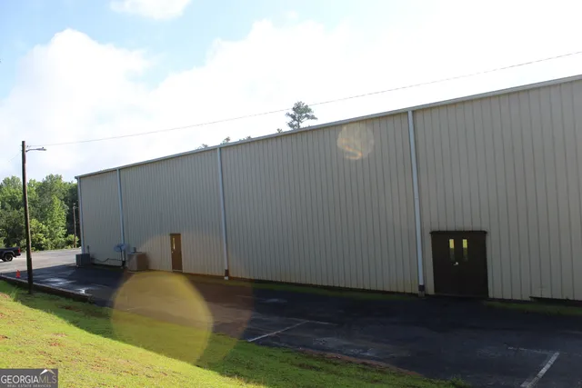 a view of a hallway with workspace and a couch