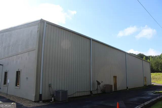 a view of a hallway with chairs and a potted plant