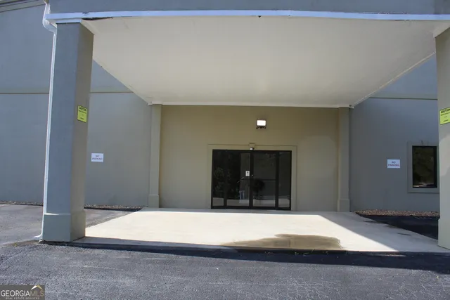 a view of a room with furniture and wooden floor