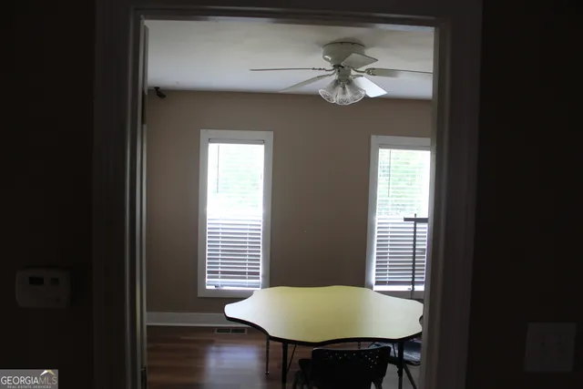 a view of a hallway with wooden floor and closet
