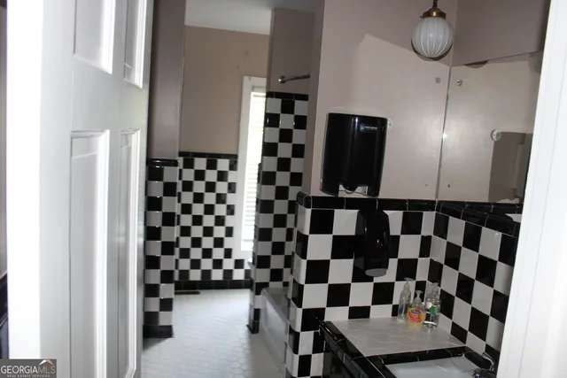 a view of a room with furniture and wooden floor