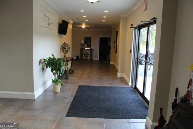 a living room with furniture and a piano