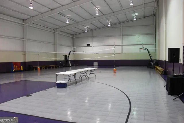 a view of a hallway with a livingroom and furniture