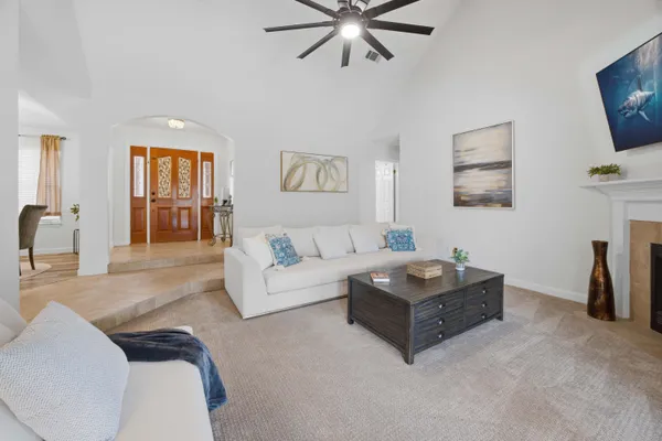 an empty room with closet and a ceiling fan
