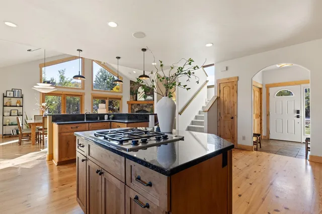 a kitchen with stainless steel appliances granite countertop a sink and a stove