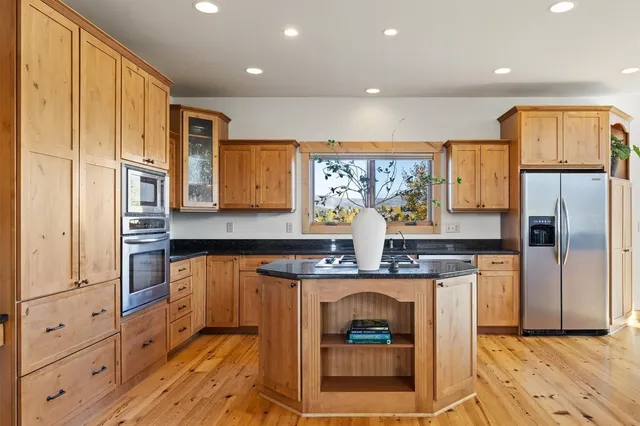 a kitchen with stainless steel appliances granite countertop a stove a refrigerator and a refrigerator