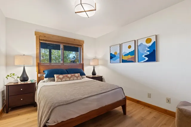 a bedroom with a bed and a painting on the wall