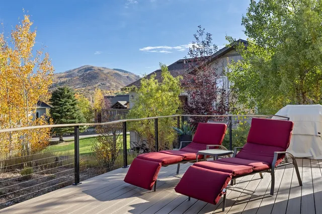 a living room with furniture a large window and a fireplace