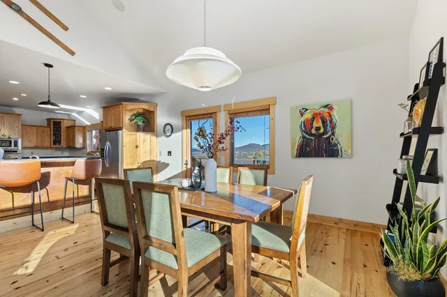 a view of a dining room with furniture and a potted plant