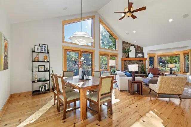a view of a dining room with furniture a rug and wooden floor