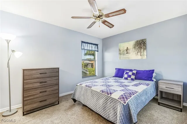 a bedroom with a bed a chandelier and a closet