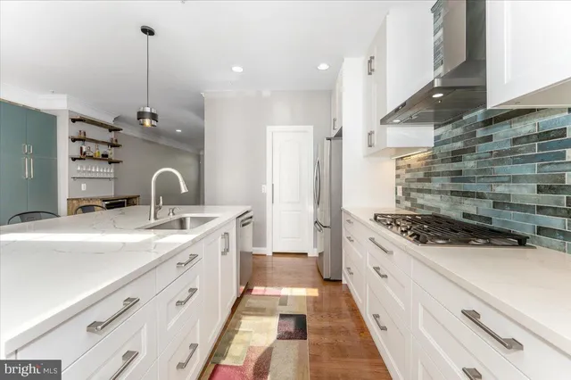 a kitchen with sink stove and cabinets