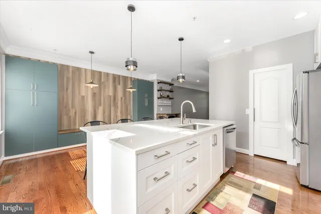 a view of a kitchen with a sink cabinets and wooden floor