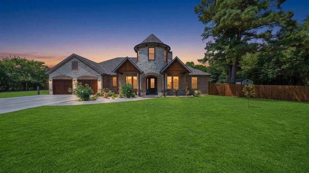 a front view of a house with yard and green space