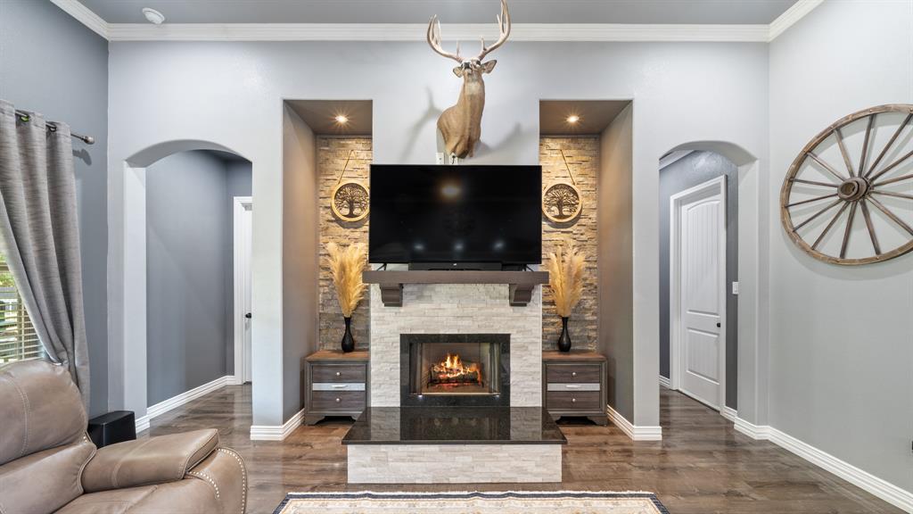 401 May Road Seagoville, TX 75159 - Photo 11 of 31 a living room with furniture a fireplace and a flat screen tv