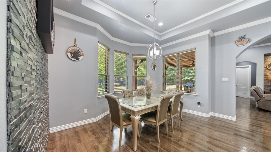 401 May Road Seagoville, TX 75159 - Photo 16 of 31 a view of a dining room with furniture window and wooden floor