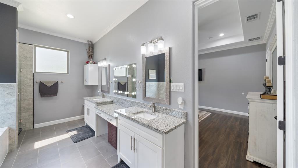 401 May Road Seagoville, TX 75159 - Photo 20 of 31 a bathroom with a granite countertop sink a mirror and a shower