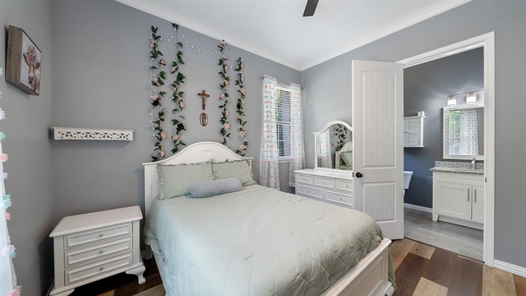 401 May Road Seagoville, TX 75159 - Photo 22 of 31 a bedroom with a bed and a chandelier