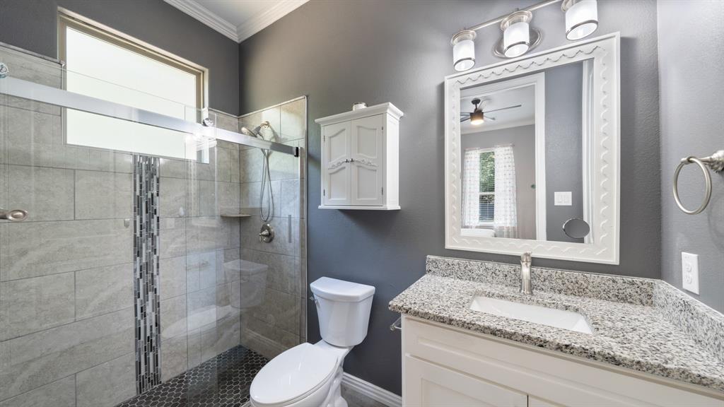 401 May Road Seagoville, TX 75159 - Photo 23 of 31 a bathroom with a granite countertop sink toilet and shower