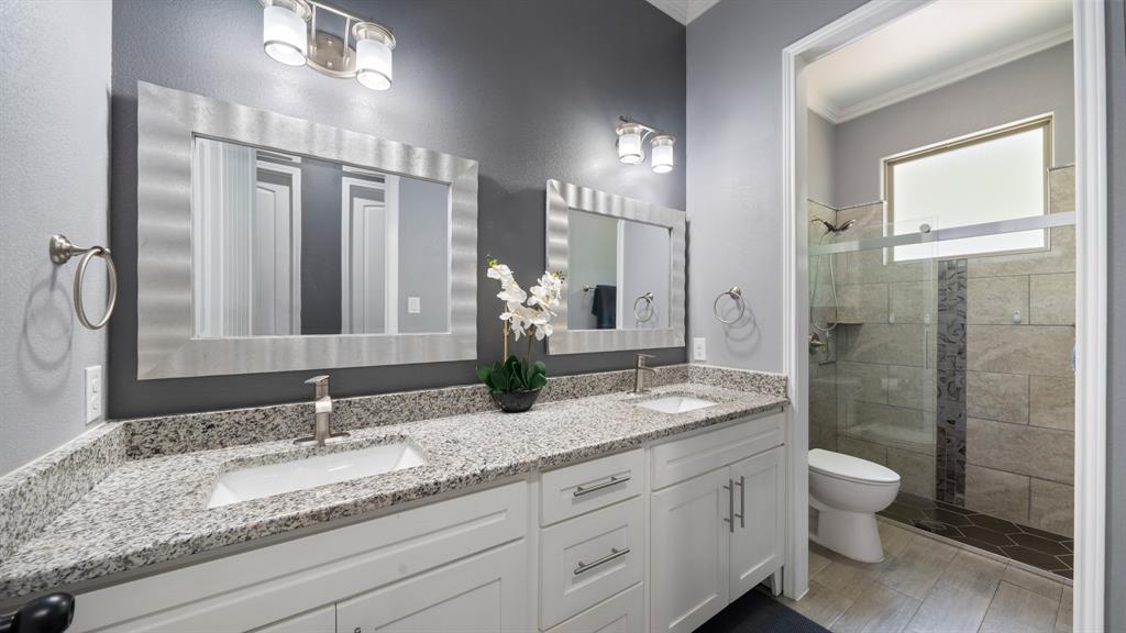 401 May Road Seagoville, TX 75159 - Photo 26 of 31 a bathroom with a granite countertop double vanity sink toilet and shower