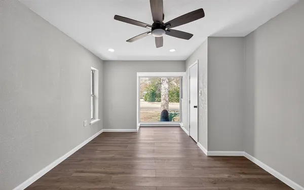 wooden floor in an empty room with a window