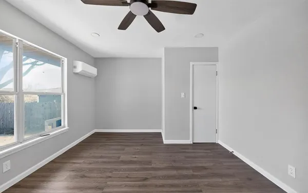 a view of an empty room with wooden floor