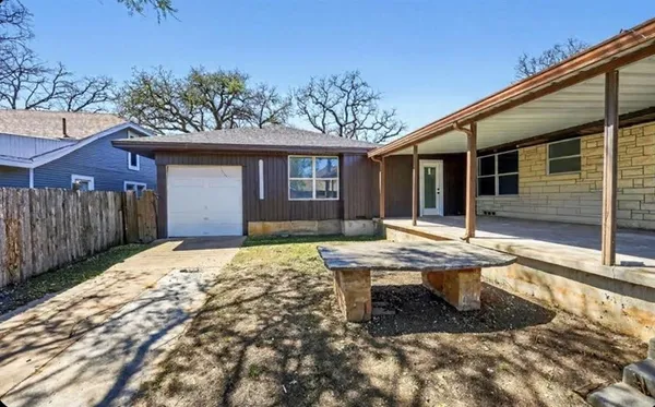 a view of empty room with wooden floor and fireplace