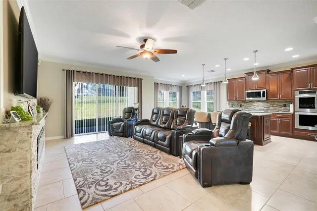a living room with fireplace furniture and a potted plant
