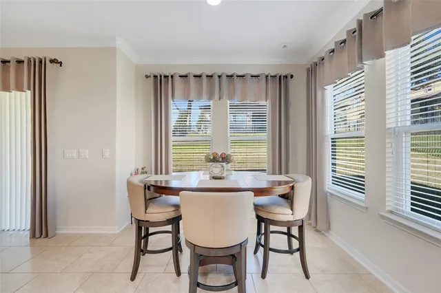 a dining room with furniture and window