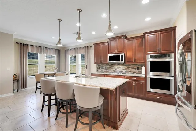 a large kitchen with a table and chairs