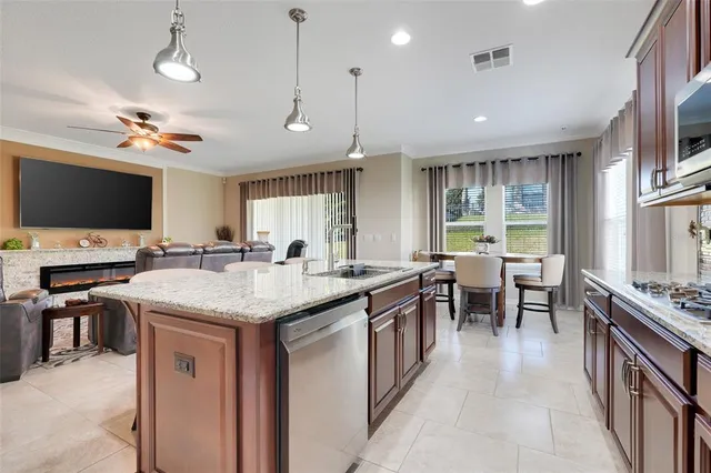 a kitchen with counter space appliances and a ceiling fan