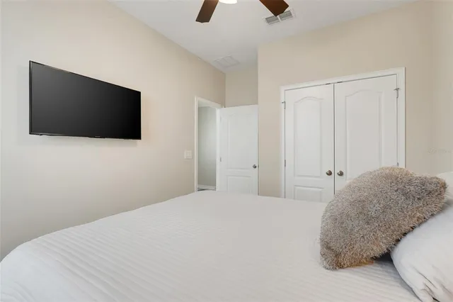 a bedroom with a bed and a flat screen tv