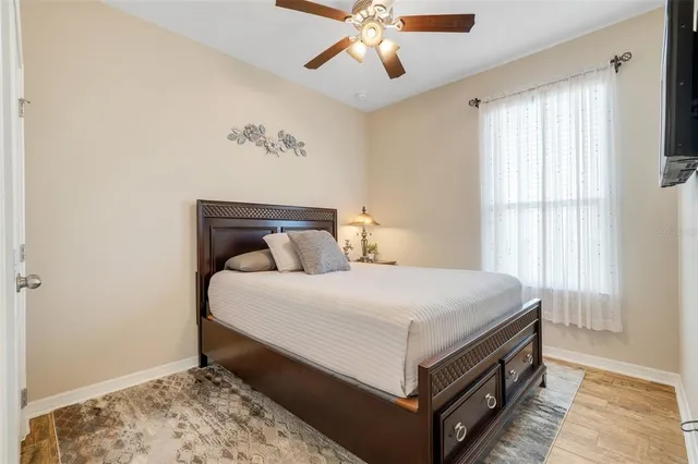 a bed sitting in a bedroom next to a window