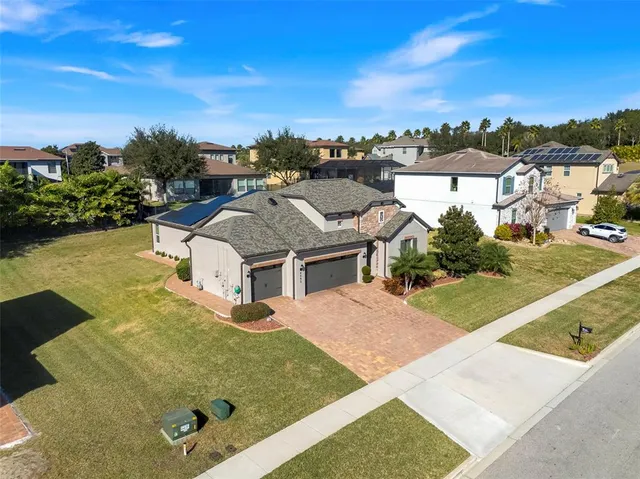 an aerial view of a house with a yard