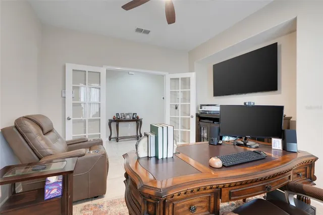 a dining room with furniture and a flat screen tv