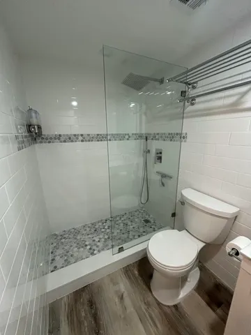 a bathroom with a toilet and a shower